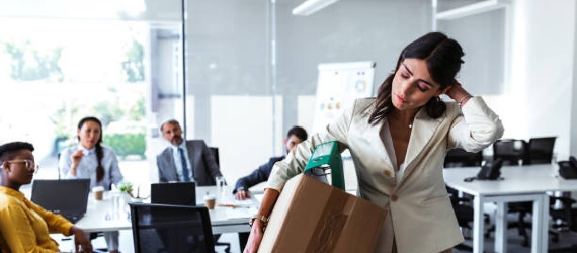 Stress of business woman packing brown cardboard box her belonging after resign and signing cancellation contract letter, Change of job unemployment or resignation concept